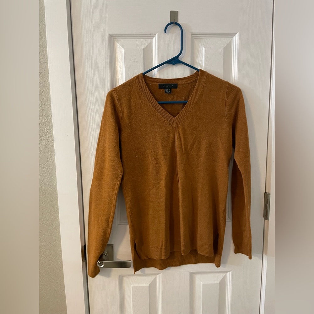 Burnt orange sweater with detail on the front